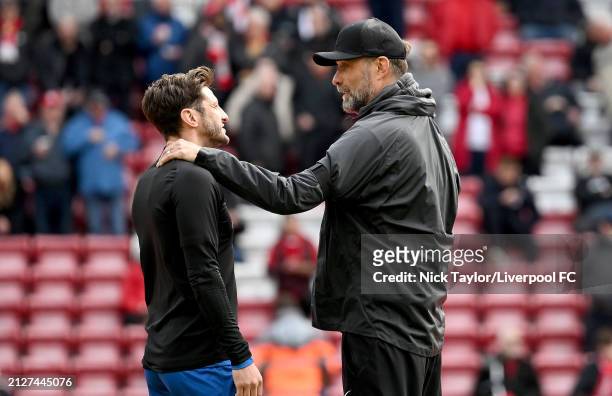 Manager Jurgen Klopp of Liverpool and Adam Lallana of Brighton & Hove Albion during the Premier League match between Liverpool FC and Brighton & Hove...