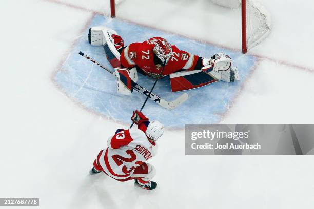 Goaltender Sergei Bobrovsky of the Florida Panthers stops a shot by Lucas Raymond of the Detroit Red Wings during the shoot out at the Amerant Bank...