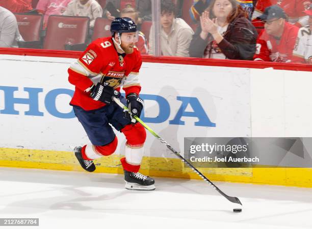 Sam Bennett of the Florida Panthers skates with the puck against the Detroit Red Wings during g overtime at the Amerant Bank Arena on March 30, 2024...