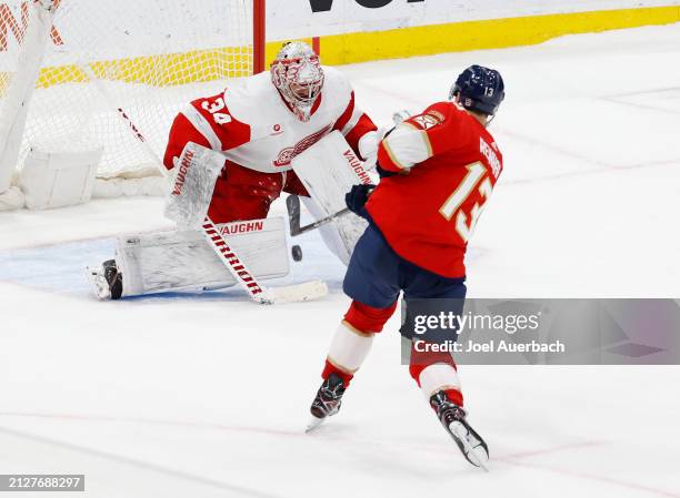 Sam Reinhart of the Florida Panthers scores a goal against Goaltender Alex Lyon of the Detroit Red Wings during the shoot out at the Amerant Bank...