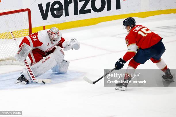 Goaltender Alex Lyon of the Detroit Red Wings stops a shot by Anton Lundell of the Florida Panthers during the shoot out at the Amerant Bank Arena on...
