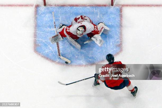 Goaltender Alex Lyon of the Detroit Red Wings stops a shot by Anton Lundell of the Florida Panthers during the shoot out at the Amerant Bank Arena on...