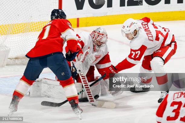 Goaltender Alex Lyon of the Detroit Red Wings stops a shot by Nick Cousins of the Florida Panthers at the Amerant Bank Arena on March 30, 2024 in...