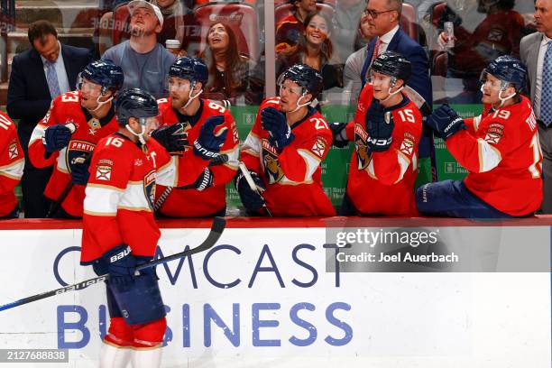 Teammates congratulate Aleksander Barkov of the Florida Panthers after he scored a third period goal against the Detroit Red Wings at the Amerant...