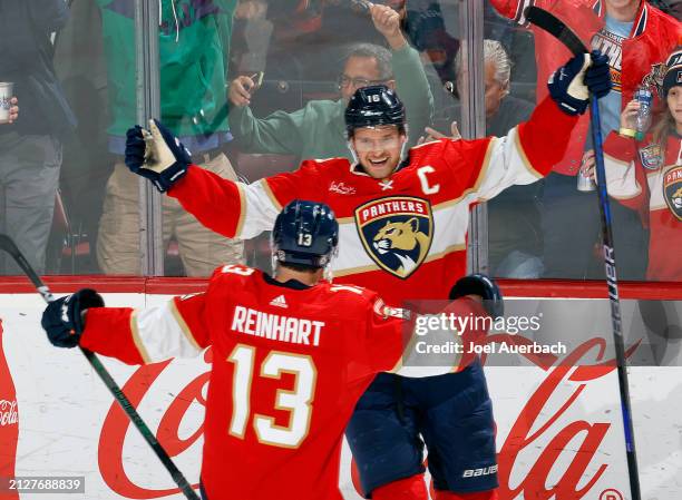 Aleksander Barkov celebrates his third period goal with Sam Reinhart of the Florida Panthers against the Detroit Red Wings at the Amerant Bank Arena...