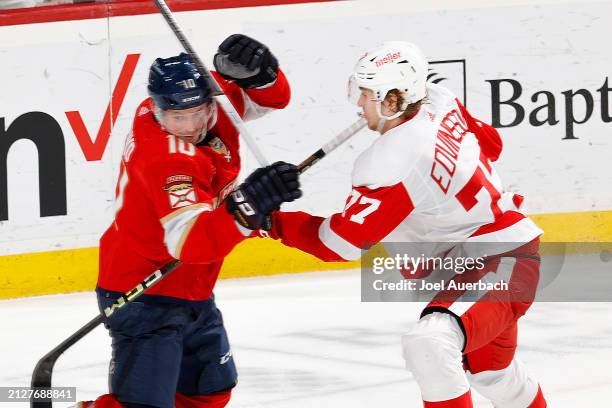 Vladimir Tarasenko of the Florida Panthers and Simon Edvinsson of the Detroit Red Wings battle at the side of the net at the Amerant Bank Arena on...