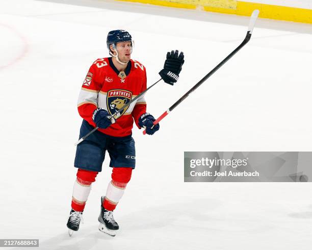 Carter Verhaeghe skates to the penalty box with the stick and glove belonging to Aaron Ekblad of the Florida Panthers after a fight with Alex...