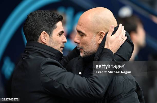 Mikel Arteta, Manager of Arsenal, interacts with Pep Guardiola, Manager of Manchester City, prior to the Premier League match between Manchester City...