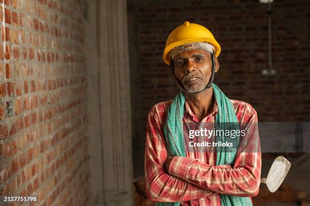 senior worker in construction building site - indian mason stock pictures, royalty-free photos & images