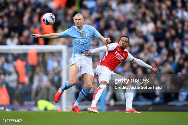 Erling Haaland of Manchester City is challenged by Gabriel of Arsenal during the Premier League match between Manchester City and Arsenal FC at...