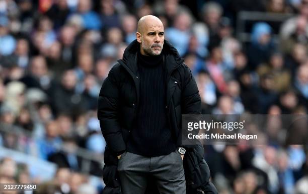 Pep Guardiola, Manager of Manchester City, looks on during the Premier League match between Manchester City and Arsenal FC at Etihad Stadium on March...