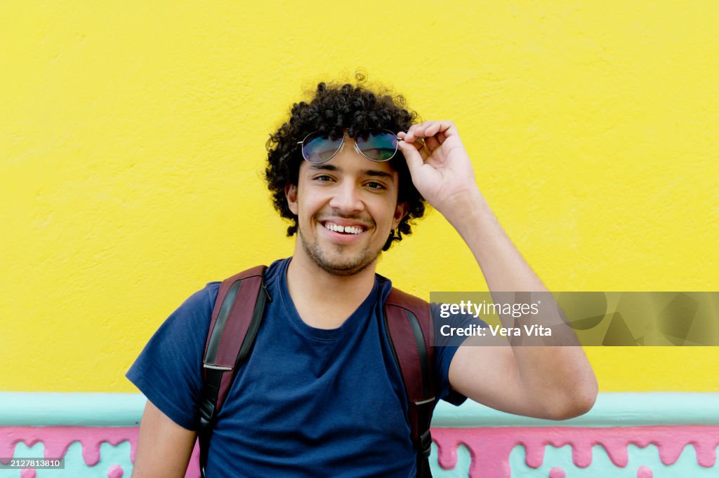 Portrait of hispanic man traveling in Guatape colorful city