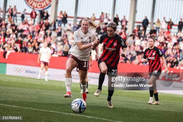 Jill Baijings of FC Bayern München challenged by Sara Doorsoun-Khajeh of Eintracht Frankfurt during the Women's DFB Cup semifinal match between FC...