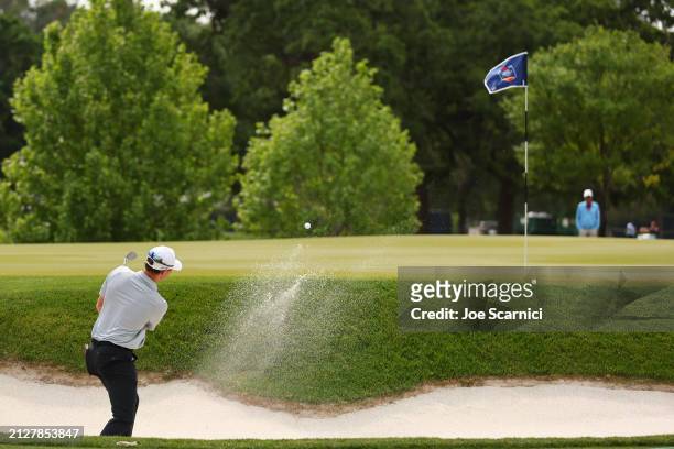 Max Greyserman of the United States plays a shot from a bunker on the first hole during the final round of the Texas Children's Houston Open at...