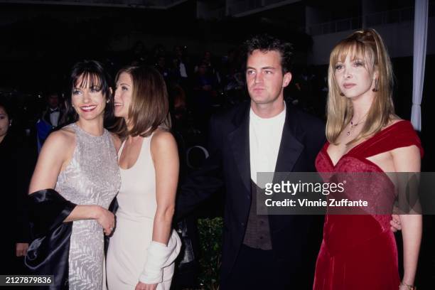 American actress Courteney Cox, wearing a sleeveless silver round neck evening gown, American actress Jennifer Aniston, who wears a white scoop neck...