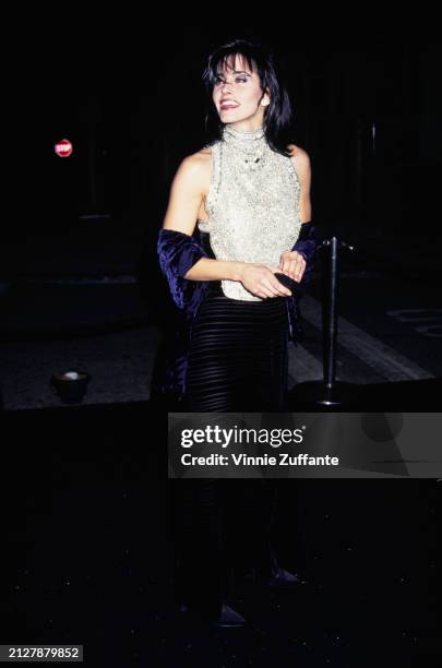 American actress Courteney Cox, wearing a silver-and-black outfit with a midnight blue evening wrap, attends the 5th Annual Fire & Ice Ball, held at...