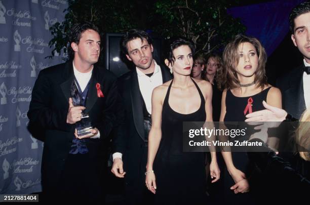 American actor Matthew Perry, wearing a black suit over a blue waistcoat and white shirt, American actor Matt LeBlanc, who wears a black suit,...