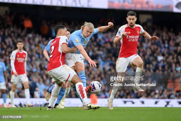 Erling Haaland of Manchester City is challenged by William Saliba of Arsenal during the Premier League match between Manchester City and Arsenal FC...