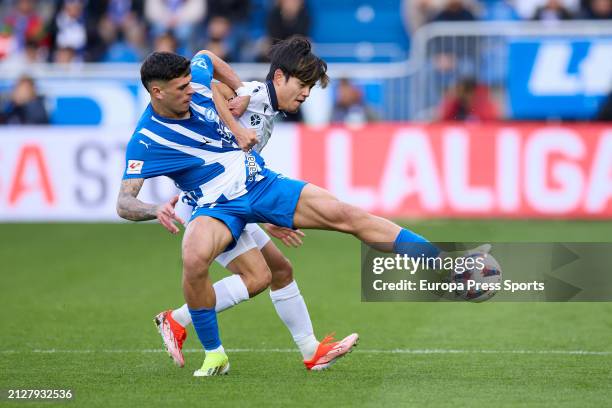 Javi Lopez of Deportivo Alaves competes for the ball with Takefusa Kubo of Real Sociedad during the LaLiga EA Sports match between Deportivo Alaves...