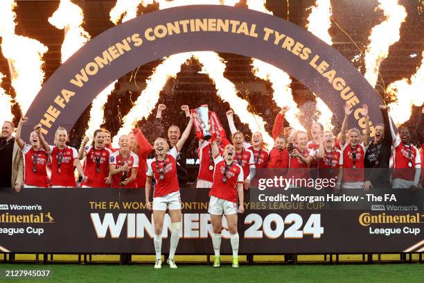 Leah Williamson and Kim Little of Arsenal lift the Continental Tyres League Cup Trophy after their team's victory in the FA Women's Continental Tyres...