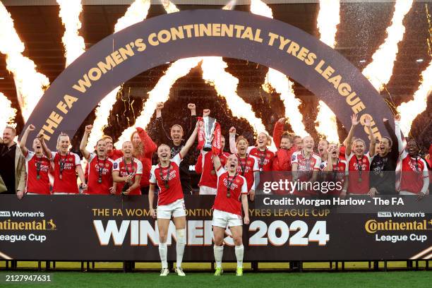 Leah Williamson and Kim Little of Arsenal lift the Continental Tyres League Cup Trophy after their team's victory in the FA Women's Continental Tyres...