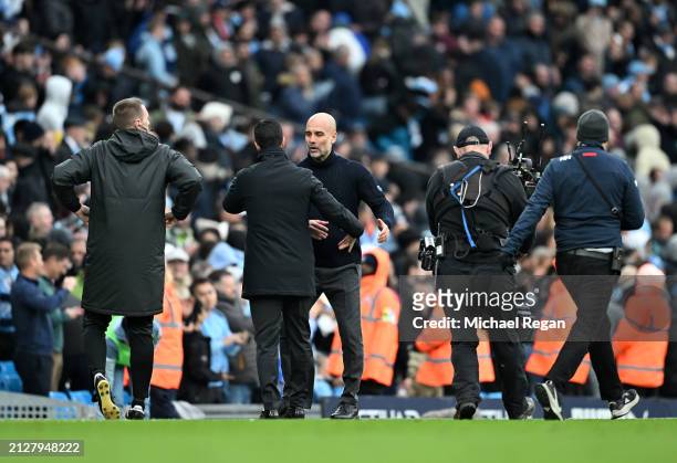 Mikel Arteta, Manager of Arsenal, interacts with Pep Guardiola, Manager of Manchester City, after the Premier League match between Manchester City...
