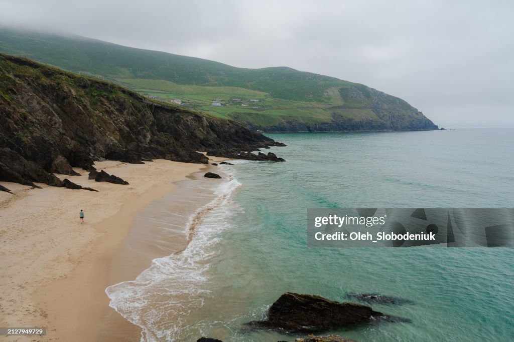Man walking on the beach in Ireland in summer