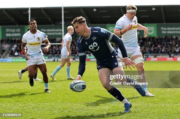 Tom Roebuck of Sale Sharks scores the first of his three tries during the Gallagher Premiership Rugby match between Sale Sharks and Exeter Chiefs at...