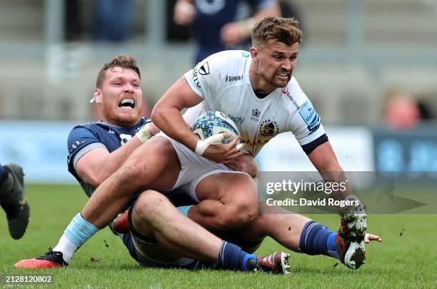 Henry Slade of Exeter Chiefs is held by Cobus Wiese during the Gallagher Premiership Rugby match between Sale Sharks and Exeter Chiefs at the AJ Bell...