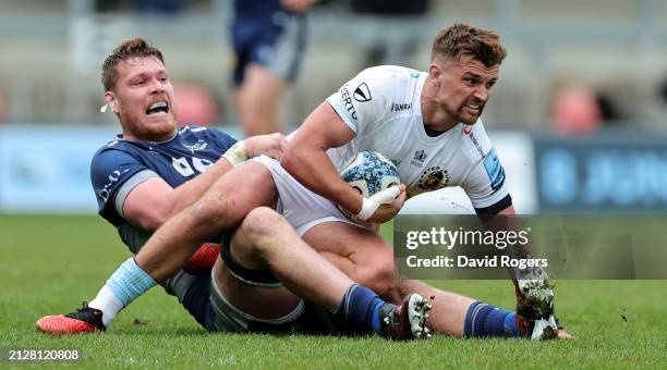 Henry Slade of Exeter Chiefs is held by Cobus Wiese during the Gallagher Premiership Rugby match between Sale Sharks and Exeter Chiefs at the AJ Bell...