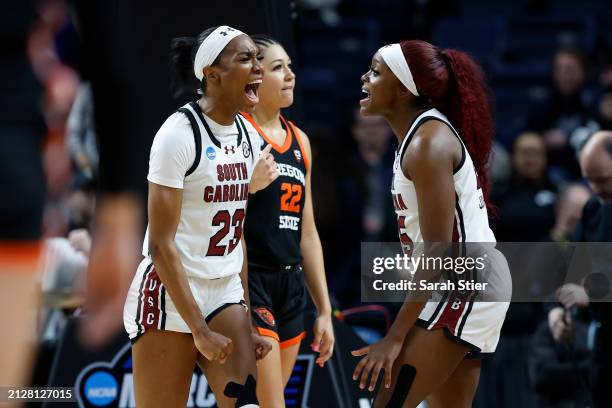 Bree Hall celebrates with Raven Johnson of the South Carolina Gamecocks during the second half against the Oregon State Beavers in the Elite 8 round...
