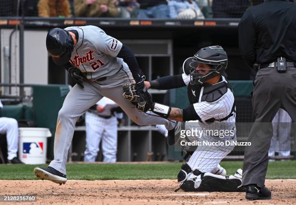 Mark Canha of the Detroit Tigers is tagged out at home by Korey Lee of the Chicago White Sox during the sixth inning of a game at Guaranteed Rate...