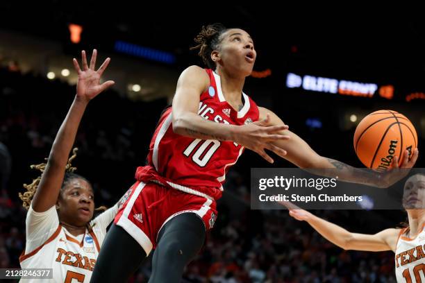 Aziaha James of the NC State Wolfpack shoots over DeYona Gaston of the Texas Longhorns during the first half in the Elite 8 round of the NCAA Women's...