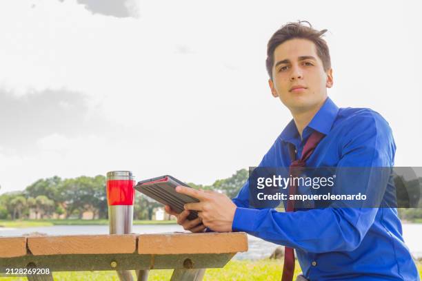 portrait of millennial and gen z young male business man stock exchange trader broker / real estate agent looking to the camera - ethnic millennial real estate stockfoto's en -beelden