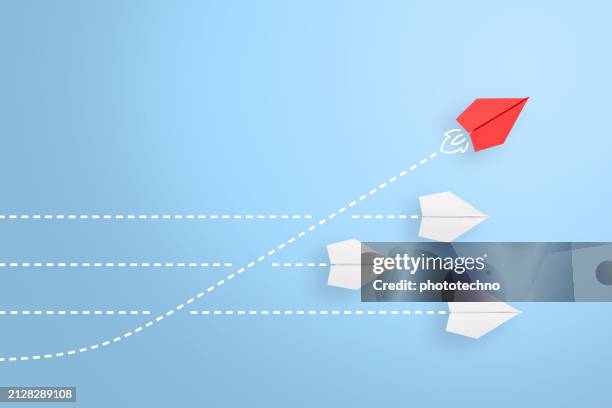 change concepts with red paper airplane leading among white - beslutsamhet bildbanksfoton och bilder