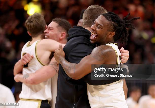 Lance Jones of the Purdue Boilermakers celebrates with his teammates after defeating the Tennessee Volunteers in the Elite 8 round of the NCAA Men's...