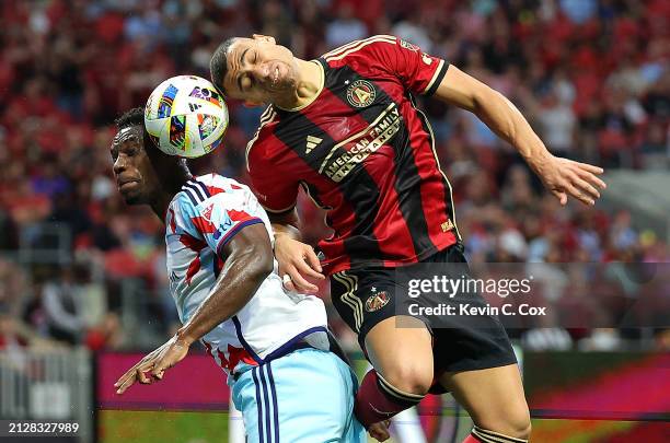 Giorgos Giakoumakis of Atlanta United attempts a shot on goal against Carlos Terán of Chicago Fire during the first half at Mercedes-Benz Stadium on...