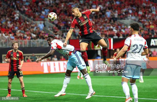Giorgos Giakoumakis of Atlanta United attempts a shot on goal against Carlos Terán of Chicago Fire during the first half at Mercedes-Benz Stadium on...