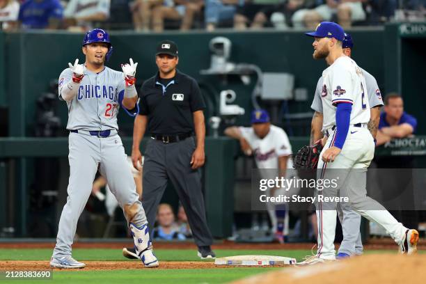 Seiya Suzuki of the Chicago Cubs reacts to an RBI single against the Texas Rangers during the ninth inning at Globe Life Field on March 31, 2024 in...