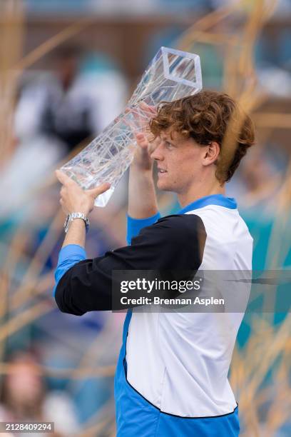 Jannik Sinner of Italy celebrates with the trophy after defeating Grigor Dimitrov of Bulgaria 6-3, 6-1 in the men's final of the Miami Open at Hard...