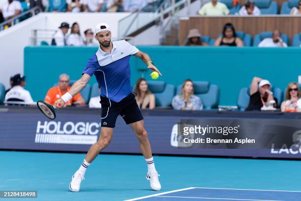 Grigor Dimitrov of Bulgaria returns against Jannik Sinner of Italy in the men's final of the Miami Open at Hard Rock Stadium on March 31, 2024 in...