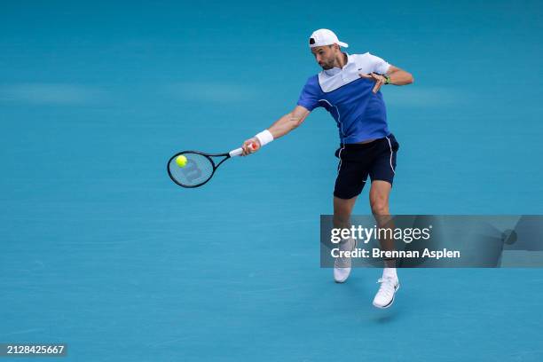 Grigor Dimitrov of Bulgaria returns against Jannik Sinner of Italy in the men's final of the Miami Open at Hard Rock Stadium on March 31, 2024 in...