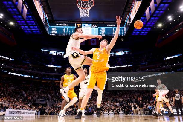 Zach Edey of the Purdue Boilermakers blocks a shot by Dalton Knecht of the Tennessee Volunteers during the second half in the Elite 8 round of the...