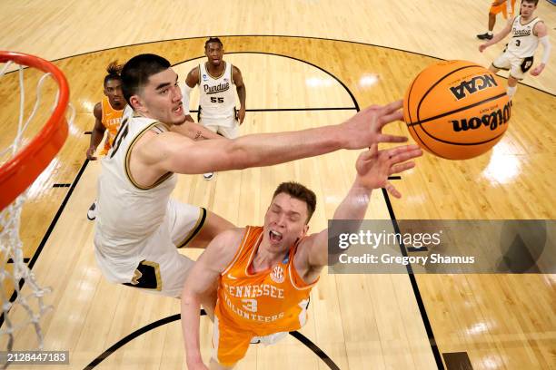 Zach Edey of the Purdue Boilermakers blocks a shot by Dalton Knecht of the Tennessee Volunteers during the second half in the Elite 8 round of the...