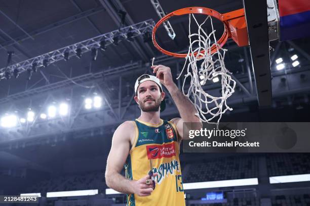 Sean Macdonald of the JackJumpers cuts the net after winning game five of the NBL Championship Grand Final Series between Melbourne United and...