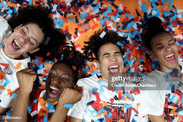 Mimi Collins, Saniya Rivers, Madison Hayes, and Aziaha James of the NC State Wolfpack celebrate after defeating the Texas Longhorns 76-66 in the...