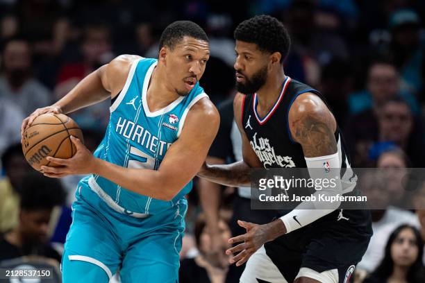 Paul George of the LA Clippers guards Grant Williams of the Charlotte Hornets in the second quarter during their game at Spectrum Center on March 31,...