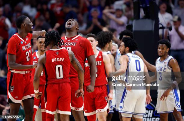 Burns Jr. #30 of the North Carolina State Wolfpack reacts after scoring and drawing a foul in the second half of the Elite 8 round of the NCAA Men's...