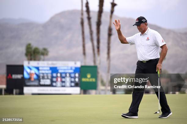 Retief Goosen of South Africa acknowledges the crowd after putting on the 18th green during the third round of The Galleri Classic at Mission Hills...