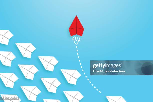 change concepts with red paper airplane leading among white - changing direction stock illustrations